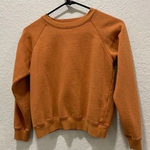 Orange Urban Outfitters crop sweater